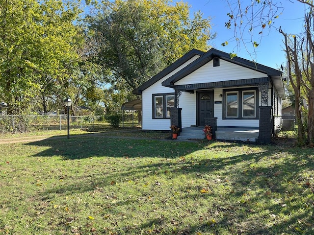 bungalow-style house with a carport and a front lawn