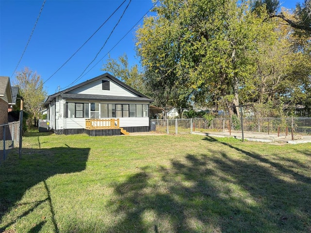 rear view of property with a lawn