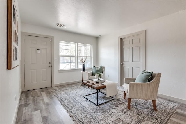 sitting room featuring light hardwood / wood-style floors