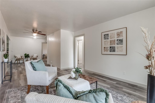 living room with ceiling fan and wood-type flooring