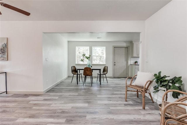 dining space featuring light wood-type flooring and ceiling fan