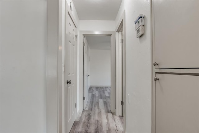 hall with light hardwood / wood-style floors