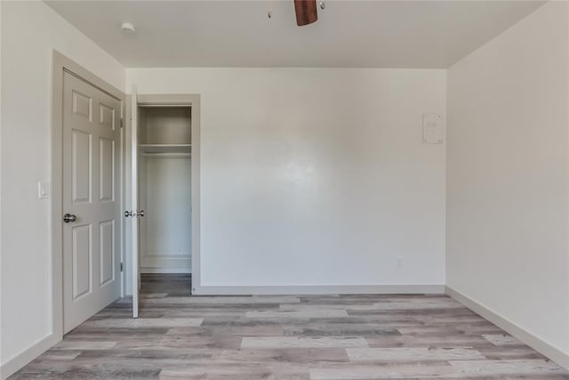 unfurnished bedroom featuring a closet, ceiling fan, and light hardwood / wood-style flooring