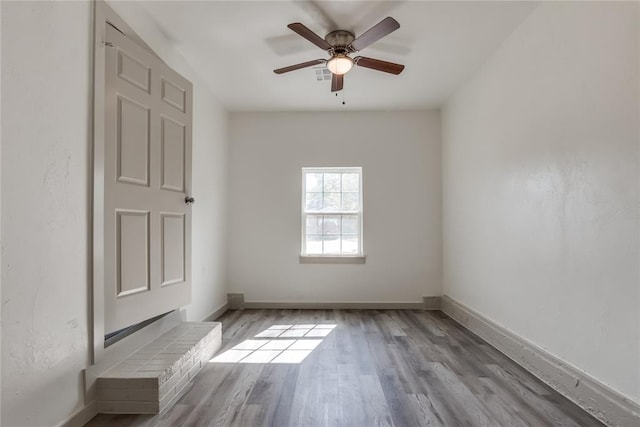 spare room featuring ceiling fan and light hardwood / wood-style flooring