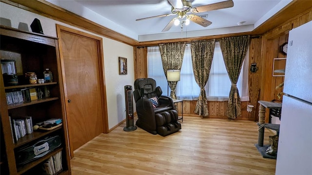 living area with ceiling fan and light wood-type flooring