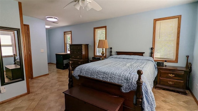 bedroom with ceiling fan and multiple windows