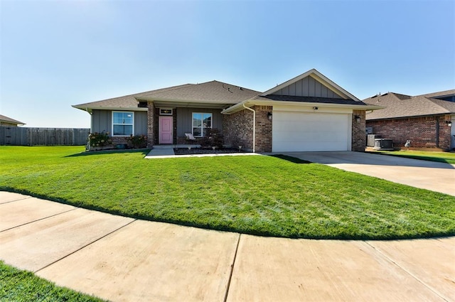 view of front of home featuring a front yard and a garage