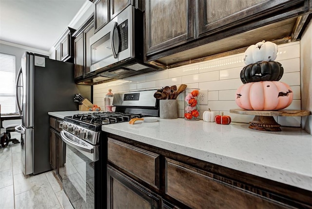 kitchen featuring light stone countertops, appliances with stainless steel finishes, backsplash, dark brown cabinetry, and crown molding