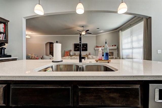 kitchen featuring decorative light fixtures, ceiling fan, and crown molding