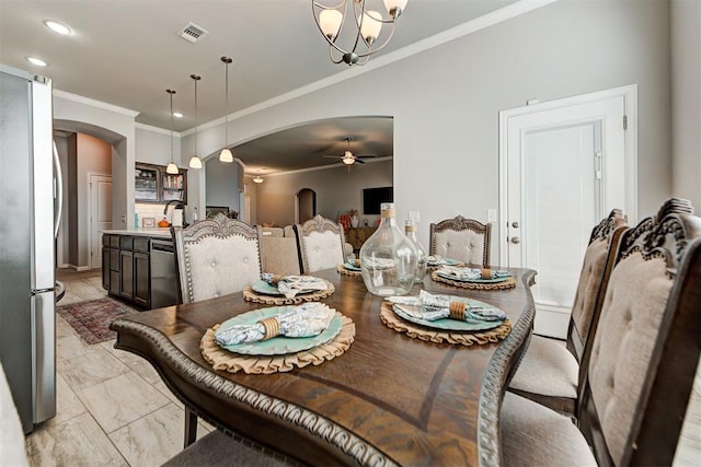 dining area featuring ceiling fan with notable chandelier and ornamental molding