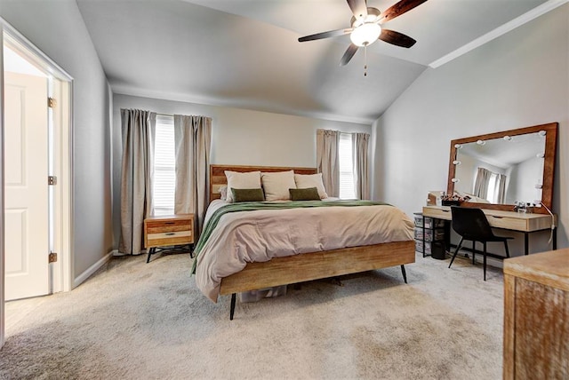 bedroom featuring ceiling fan, lofted ceiling, light carpet, and multiple windows