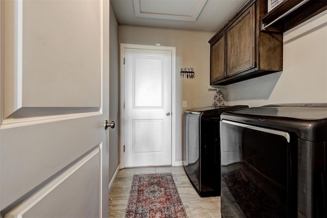 laundry room featuring cabinets and washing machine and dryer