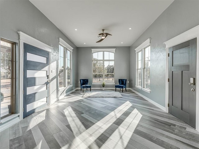 unfurnished room with ceiling fan and light wood-type flooring