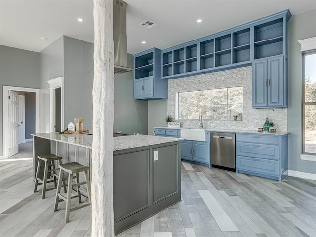 kitchen with dishwasher, light stone countertops, light wood-type flooring, and sink