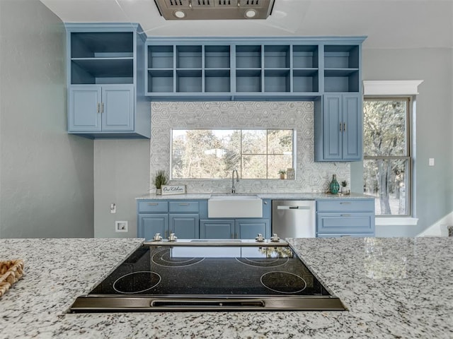 kitchen featuring dishwasher, backsplash, sink, light stone countertops, and blue cabinetry