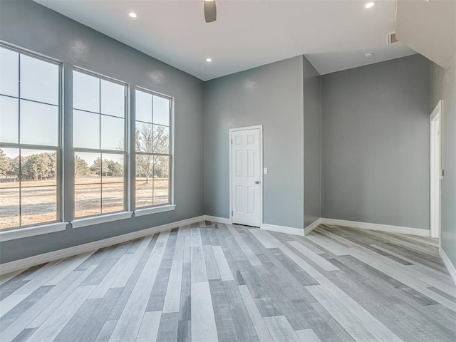 spare room with ceiling fan and light hardwood / wood-style floors