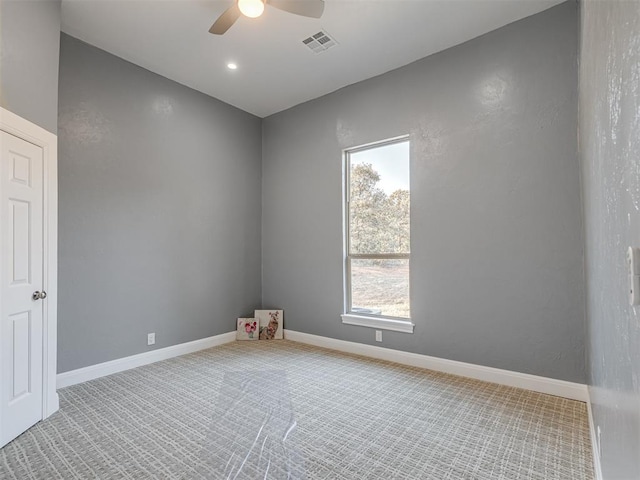 carpeted empty room featuring ceiling fan