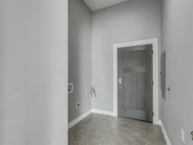 laundry room with electric dryer hookup, electric panel, light tile patterned floors, and hookup for a washing machine