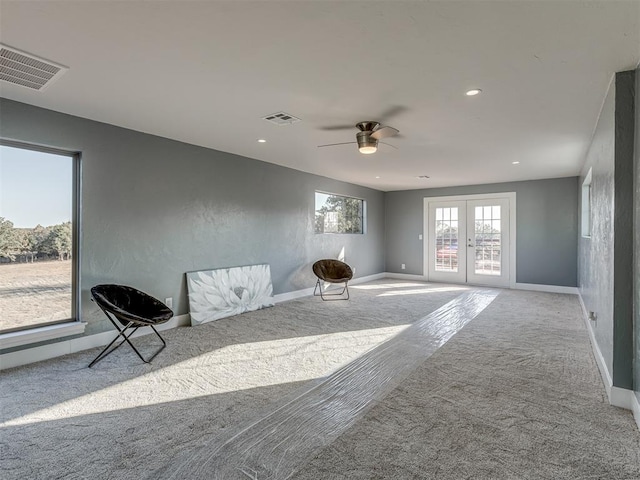 unfurnished room with ceiling fan, french doors, and carpet floors