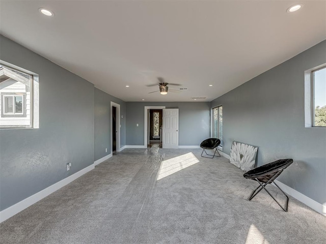 unfurnished room featuring ceiling fan and light carpet