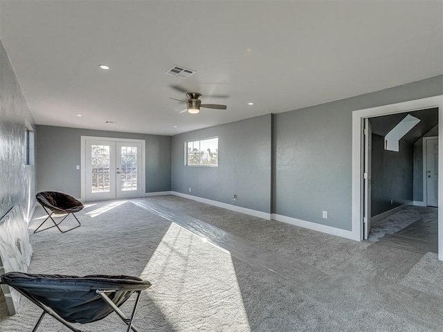 living room with ceiling fan, french doors, and carpet