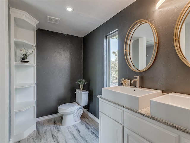 bathroom featuring hardwood / wood-style floors, vanity, and toilet