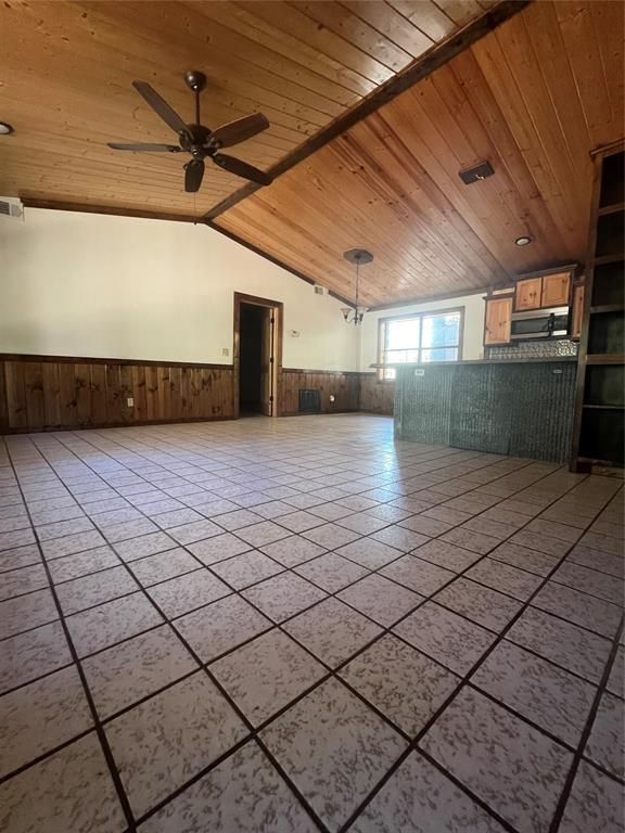 tiled empty room featuring vaulted ceiling, wooden ceiling, and ceiling fan