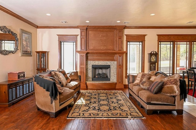 living room featuring dark hardwood / wood-style flooring, ornamental molding, and a high end fireplace