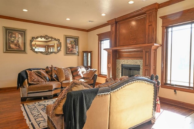 living room featuring dark hardwood / wood-style flooring, crown molding, and a wealth of natural light