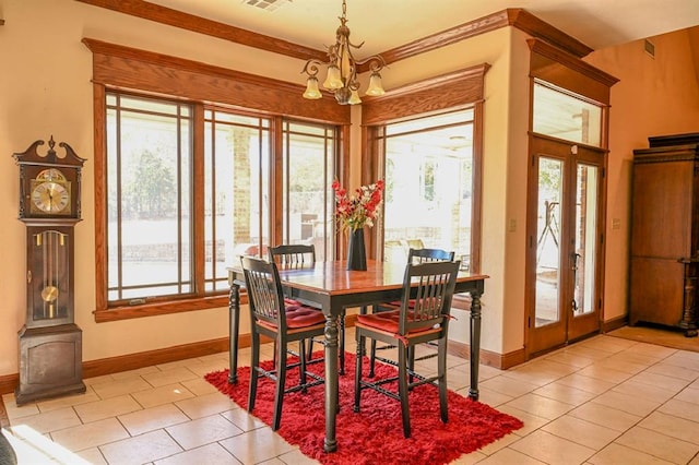 tiled dining room with a chandelier