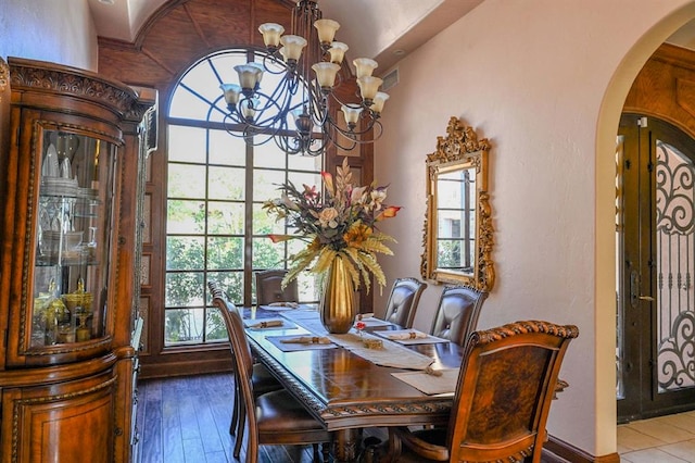 dining space featuring plenty of natural light, wood-type flooring, and a chandelier