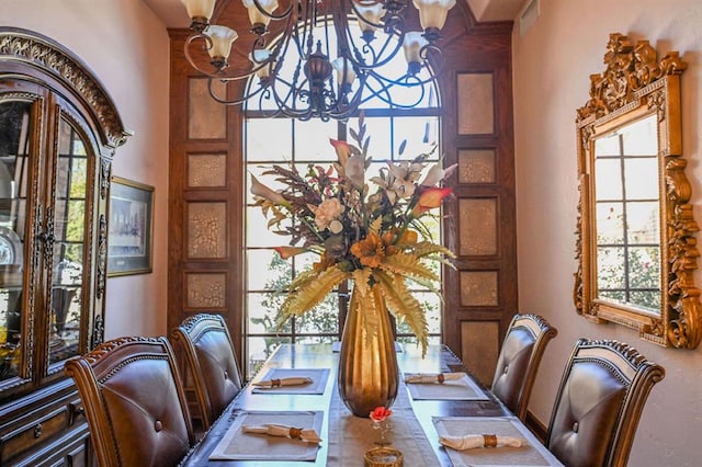 dining room featuring a healthy amount of sunlight and an inviting chandelier