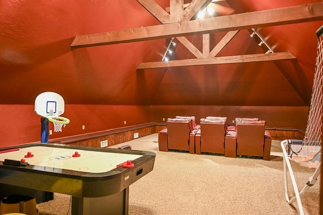 recreation room featuring vaulted ceiling with beams, rail lighting, carpet floors, and wood walls