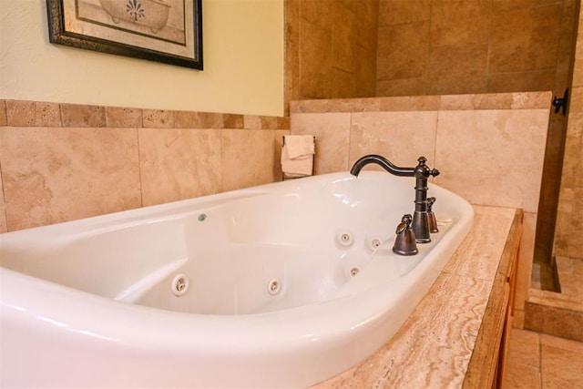 bathroom with a relaxing tiled tub