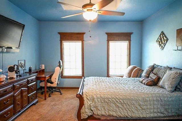 bedroom featuring light colored carpet, multiple windows, and ceiling fan