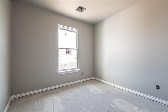 empty room with a wealth of natural light and concrete floors