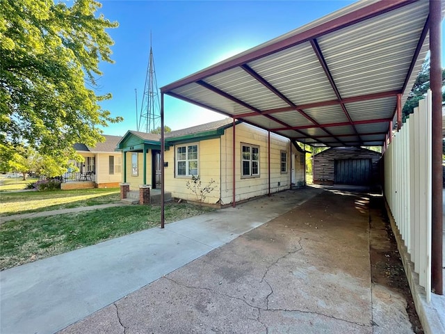 view of side of property featuring a carport, a storage shed, and a yard