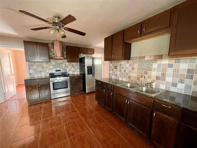 kitchen featuring ceiling fan, sink, wall chimney exhaust hood, tasteful backsplash, and appliances with stainless steel finishes