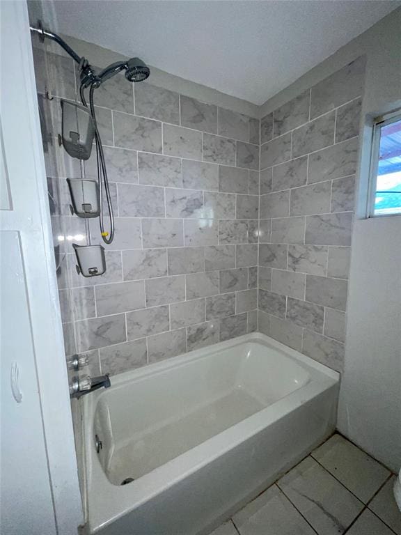 bathroom with tile patterned floors and tiled shower / bath combo