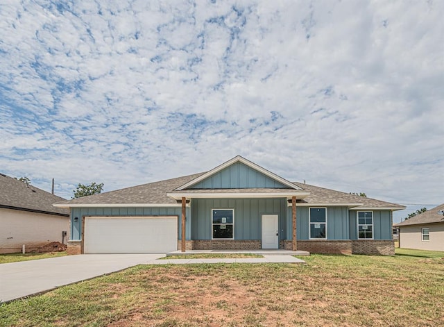 view of front of property with a garage and a front lawn