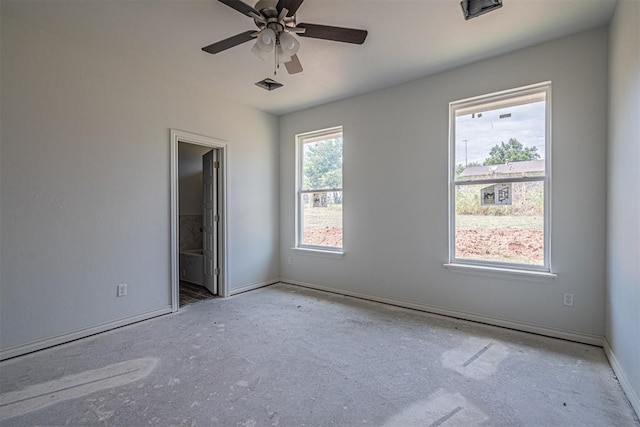 spare room with ceiling fan and a healthy amount of sunlight