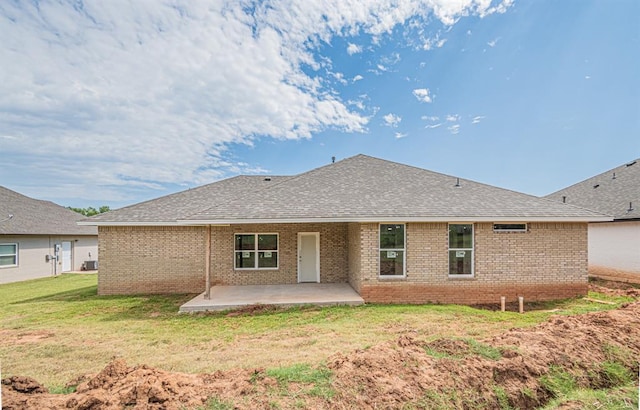 back of property with a patio area and a yard