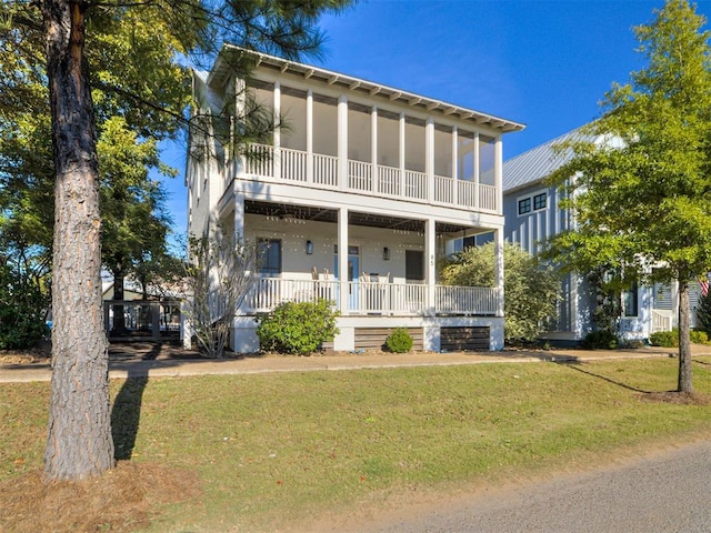 view of front of house featuring covered porch and a front yard