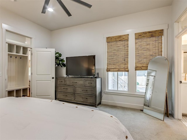 bedroom featuring light colored carpet and ceiling fan