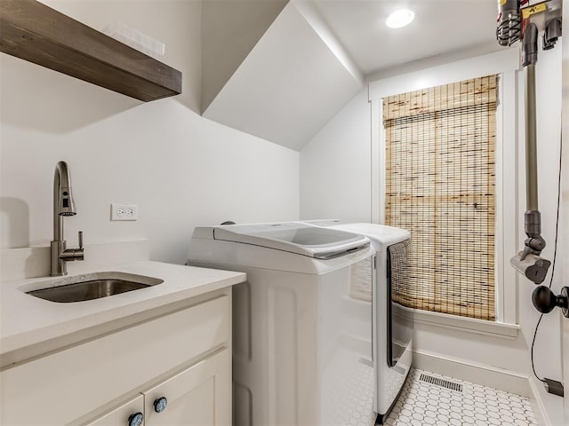 clothes washing area with cabinets, independent washer and dryer, light tile patterned floors, and sink