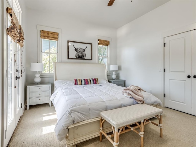 carpeted bedroom featuring a closet and ceiling fan