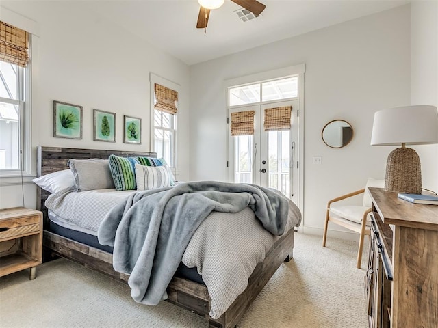 bedroom featuring access to exterior, light carpet, french doors, and ceiling fan