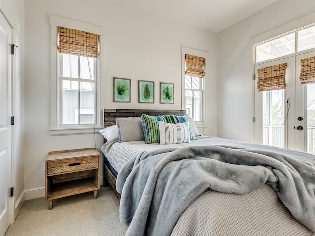 carpeted bedroom with access to exterior and multiple windows