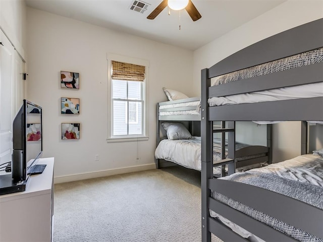 carpeted bedroom featuring a closet and ceiling fan