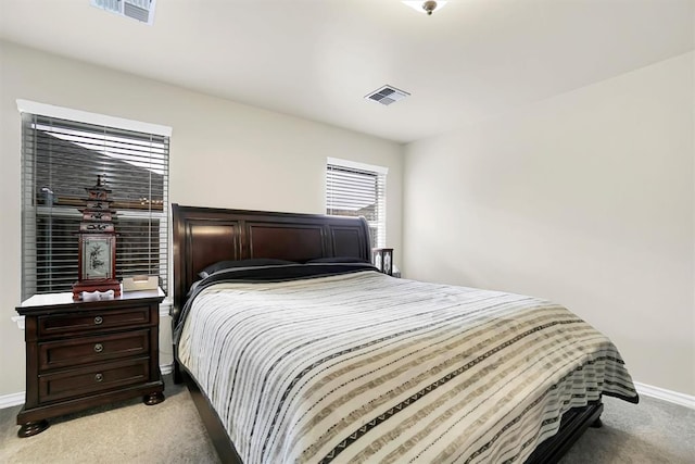 bedroom featuring light colored carpet, visible vents, and baseboards